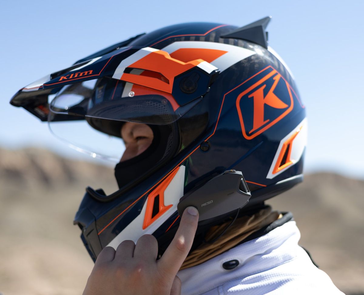 Rider adjusting an orange helmet
