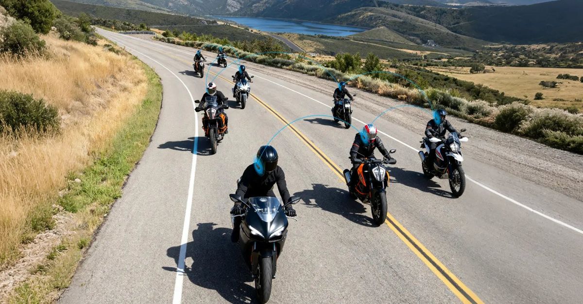 A group of riders on a coastal road